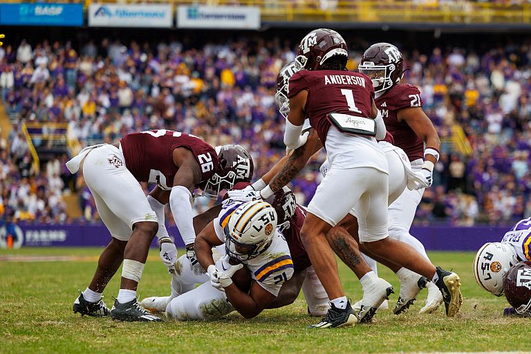 LSU Tigers running back Noah Cain (21) is tackled by Texas A&M Aggies defensive back Demani Richardson (26) during a game