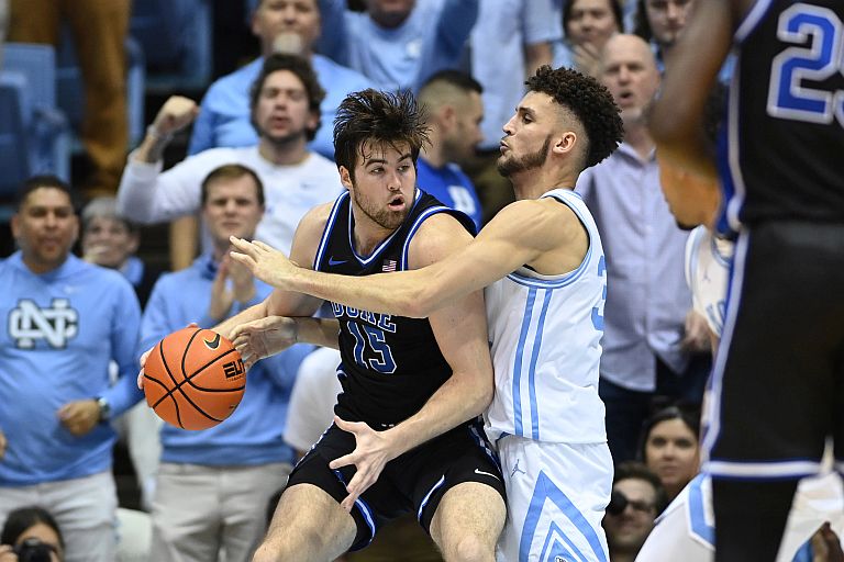 Duke Blue Devils center Ryan Young (15) with the ball as North Carolina Tar Heels forward Pete Nance (32) defends