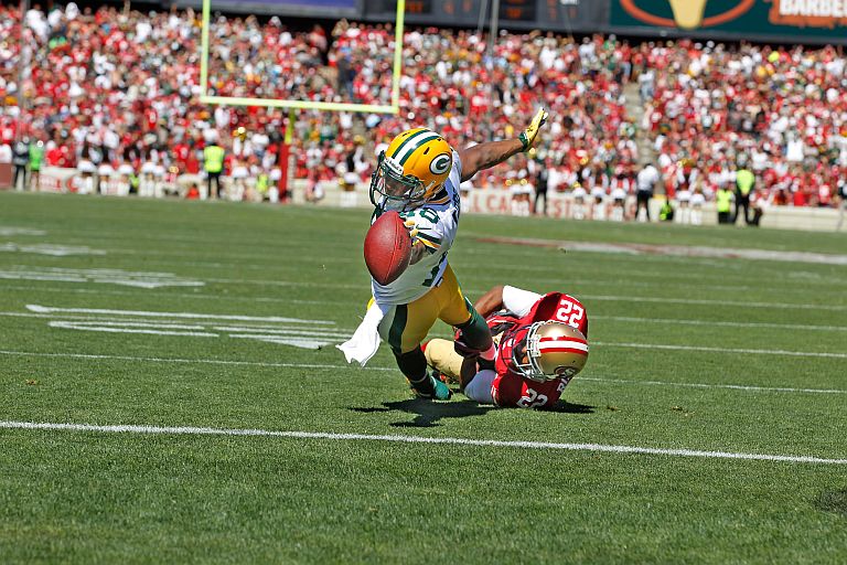 Green Bay Packers wide receiver Randall Cobb (18) scores a touchdown being defended by San Francisco 49ers cornerback Carlos Rogers