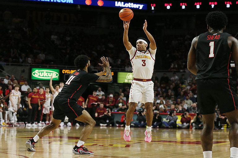 Iowa State Cyclones guard Tamin Lipsey (3) takes a three-point shot over Houston Cougars guard Damian Dunn