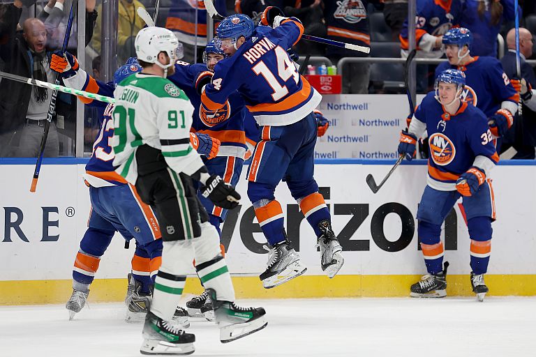 New York Islanders center Bo Horvat (14) celebrates his game winning overtime goal with teammates in front of Dallas Stars center Tyler Seguin (91)