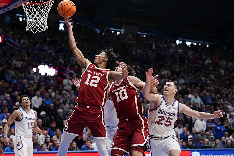 Oklahoma Sooners guard Milos Uzan (12) shoots against the Kansas Jayhawks