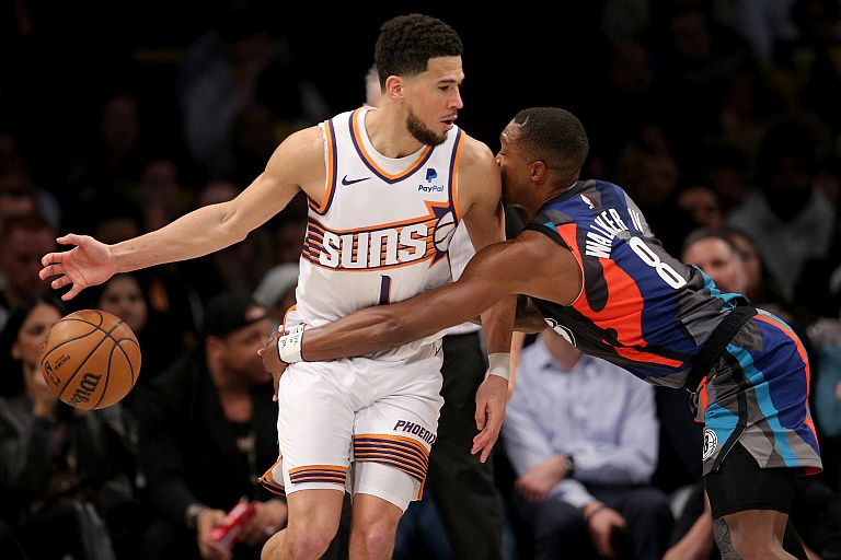 Brooklyn Nets guard Lonnie Walker IV (8) steals the ball from Phoenix Suns guard Devin Booker