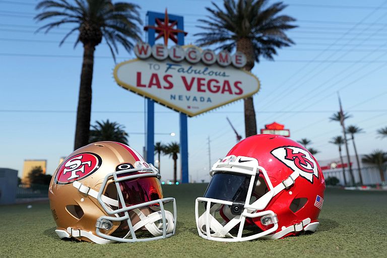 San Francisco 49ers and Kansas Chiefs helmets at the Welcome to Fabulous Las Vegas sign.