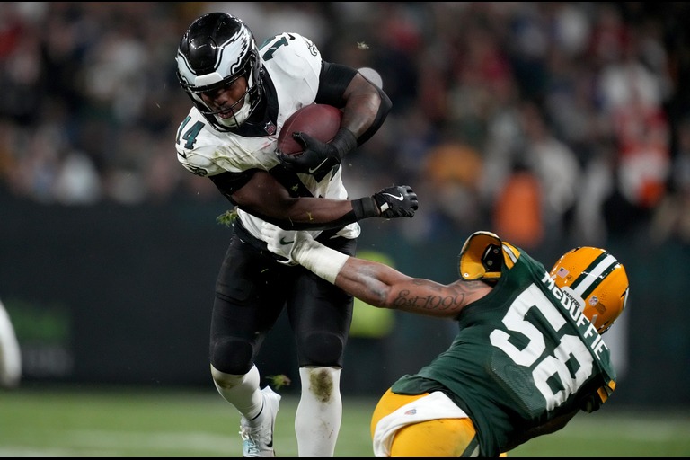 Sep 6, 2024; Sao Paulo, BRA; Philadelphia Eagles running back Kenneth Gainwell (14) breaks a tackle by Green Bay Packers linebacker Isaiah McDuffie (58) during the first half at Neo Quimica Arena. Mandatory Credit: Kirby Lee-Imagn Images